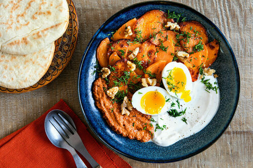 Ei an pikanter Paprika-Walnuss-Sauce mit Süßkartoffel, Joghurt und Pita
