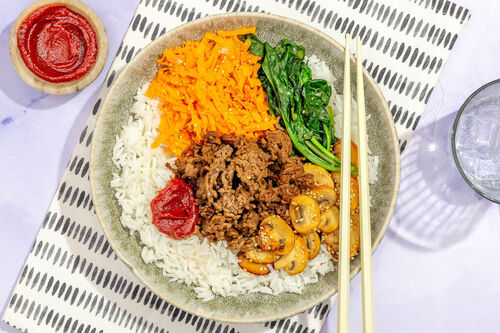 Koreanisches Bibimbap mit Rinderhack mit Vollkornreis und Spinat