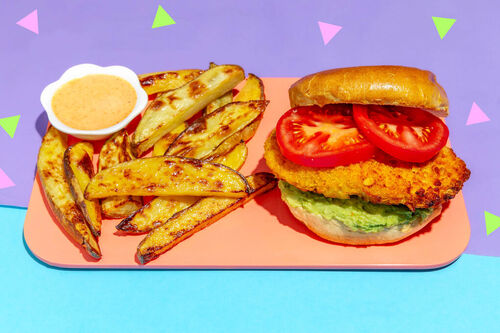 Veggie-Chicken-Burger mit Avocadocreme dazu goldbraune Ofenpommes