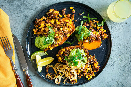 Ofen-Süßkartoffeln mit Tofu-Mais-Füllung garniert mit gerösteten Zwiebeln & Guacamole