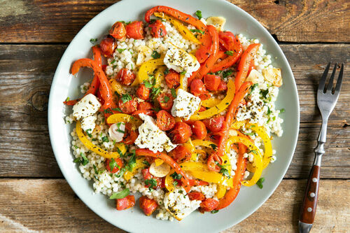Feta auf Paprika-Tomaten-Gemüse dazu zitroniger Perlencouscous mit Petersilie