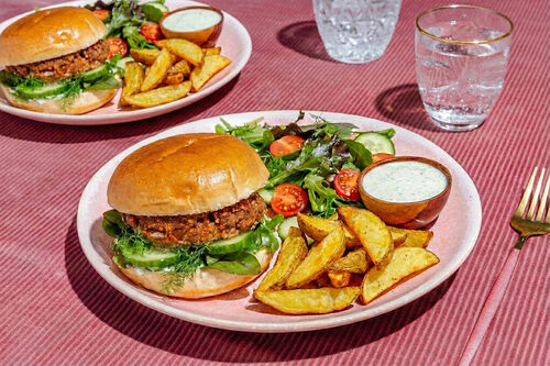 Saftiger Burger mit Feta und Bio-Rind dazu Ofenpommes und gemischter Salat