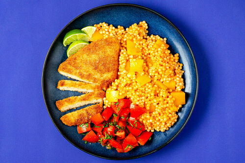 Veganes Schnitzel mit Paprika-Perlencouscous dazu Tomatensalsa und Limette