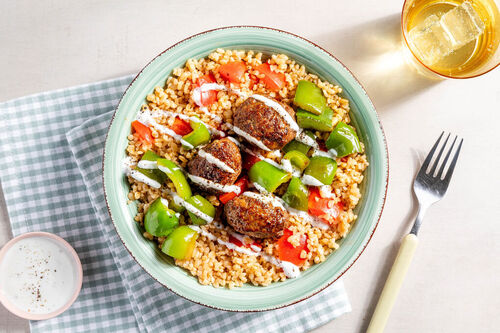Hackfleischröllchen auf Tomaten-Bulgur mit grüner Paprika und Joghurtsauce