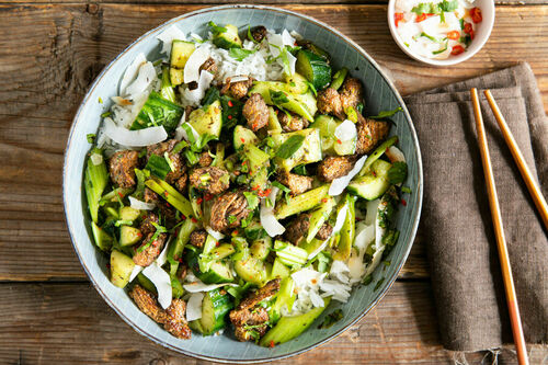 Thailändische Rindfleisch-Gurken-Pfanne auf Reis mit Kokosflocken und Koriander