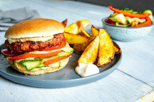 Veganer Burger mit Hummus und Gemüse dazu Kartoffelspalten und Mayodip