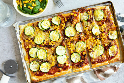 Vegane Pizza mit getrockneten Tomaten dazu Spinatsalat